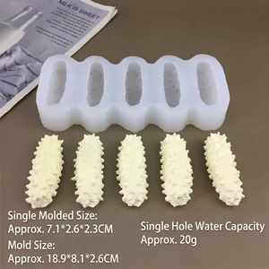 Detailed macro view of 5-cavity sea cucumber silicone mold with textured white replicas
