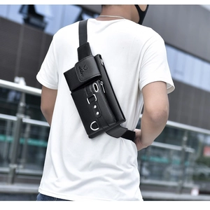 Close-up of black lychee grain PU leather sling bag with silver zippers on a male model