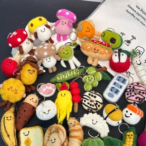 Detailed collection of handmade wool felt keychains featuring assorted fruits and food shapes