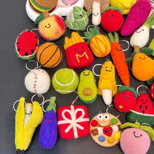 Macro of handmade felt keychains featuring fruit, vegetable, and fast food designs