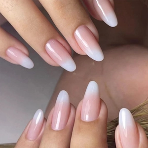 Detailed view of long almond-shaped French ombré press-on nails with high-gloss finish