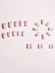 Close-up of glossy light pink gradient press-on nails set in creative circular arrangement