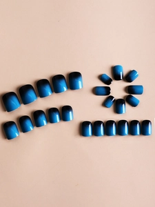 Macro detail of glossy blue and black gradient finish on short square round press-on nails