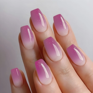 Macro detail of long coffin nails with purple ombre gradient and fine glitter shimmer