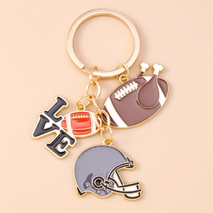 Detail of football keychain charms with LOVE letters and grey helmet in gold finish