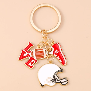 Detailed close-up of golden rugby charms including helmet, ball, shoe, and LOVE letters