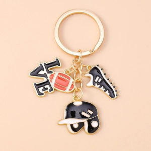 Detailed close-up of rugby themed keychain with gold LOVE charm and sports pendants
