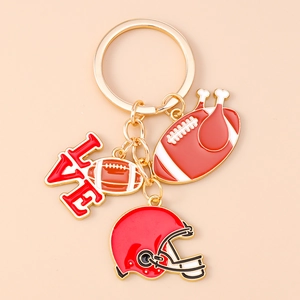 Close-up of American football keychains with helmet, ball, and LOVE charms in gold finish