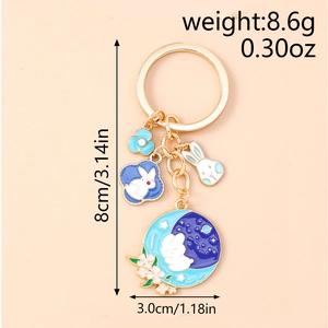 Detailed view of enamel rabbit keychain showing size dimensions and golden hardware accents