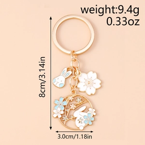 Detailed view of enamel bunny charms with dimensions and weight for the gold keychain