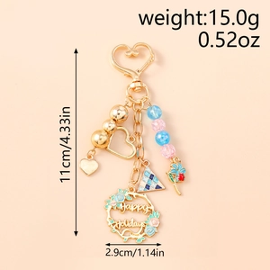 Detail showing beaded heart keychain with Happy Holidays wreath and floral charms