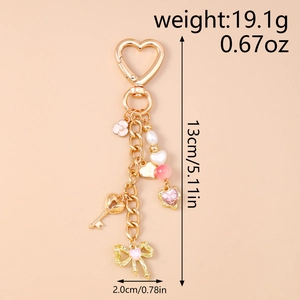 Detailed view of beaded keychain with gold heart lock and pink bow charm for bags