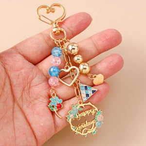 Floral wreath heart keychain with Happy Holidays pendant and colorful beads