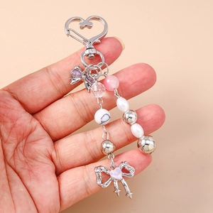 Beaded bow keychain with pink heart gem and pearlescent beads for bag accessory