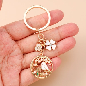 Exquisite Chinese style golden keychain with enamel bird, flowers, and elegant tassels