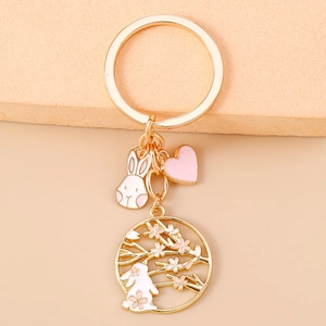 Detail of Chinese style cherry blossom rabbit keychain with pink heart and gold charms