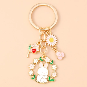 Close-up of enamel flower rabbit keychain with daisy and cherry blossom charms