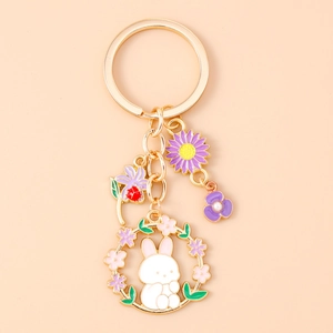 Close-up of enamel bunny floral keychain with gold plating and pearl flower details