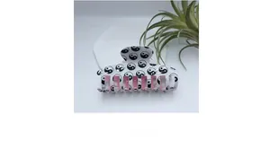 Detail view of Tai Chi hair claw clip with black white pattern and pink inner lining