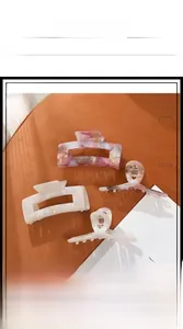 Set of four large acetate hair claws with marble texture in pink and cream tones