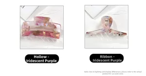 Detailed shot of iridescent purple acetate hair claws in hollow and ribbon-shaped designs