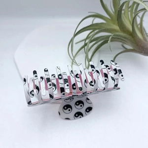 Classic Yin Yang Tai Chi hair claw clip with black and white resin pattern for hair styling