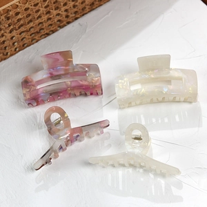 Set of four French acetate hair claws in marble purple and pearl white shell textures