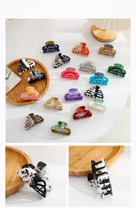 Macro view of rhinestone-studded hollow ponytail clips in various acrylic patterns