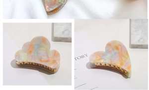 Detail of cloud and heart acetate hair claws with macaron rainbow marble texture