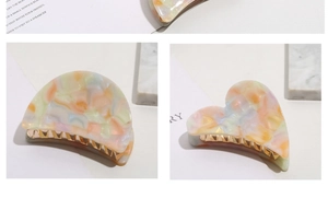 Detail of sweet cloud heart acetate hair claws with macaron marble texture and gold metal spring