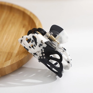 Elegant black and white marble pattern acrylic hair claw clip with rhinestones and gold spring