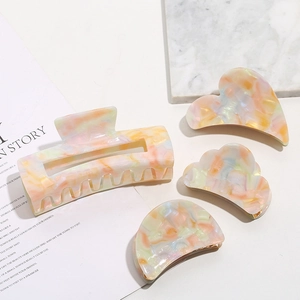 Set of four acetate hair claws in heart and cloud shapes with colorful marble textures