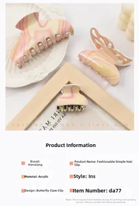 Detailed macro view of the butterfly-shaped acrylic hair claw with marble texture finish