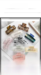 Flat lay of eight large rectangular hair claws with gradient and marble patterns