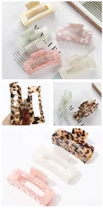Macro detail of large rectangular acetate hair claw clips with elegant marble patterns