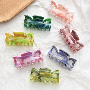 Medium acrylic bow hair claw clips in marble patterns and multiple colors for women