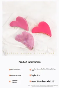 Close-up of heart-shaped acetate hair claws in pink, magenta, and marble purple textures