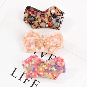 Three-piece acetic acid hair clips with gold bow patterns in tortoiseshell and marble patterns