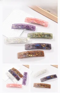 Detail view of multi-color marble texture acetate hair clips set with spring fastner