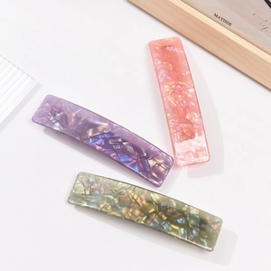 Three acrylic marble texture hair clips in pink, blue and green colors