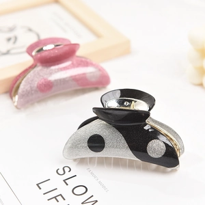 Classic Yin Yang style acrylic hair claw clip with glitter finish and polka dot pattern