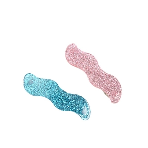 Glittery blue and pink wave-shaped hair clips set with glossy acrylic finish