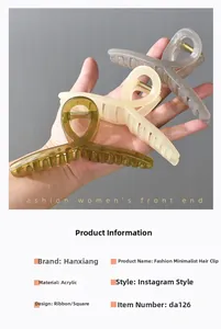 Three large acrylic shark hair clips in olive green, cream yellow, and light grey colors