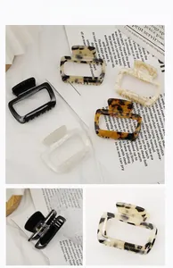 Close-up of acetate square hair claws showing marbled patterns and durable spring hinge