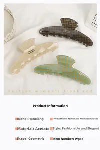 Detailed macro view of large acetate hair claws with retro checkerboard patterns