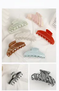 Macro detail of acetate shark hair claw clips with colorful marble and stripe patterns