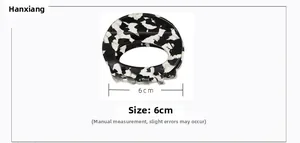 Close-up of 6cm black and white marble acetate butterfly hair claw with size markings