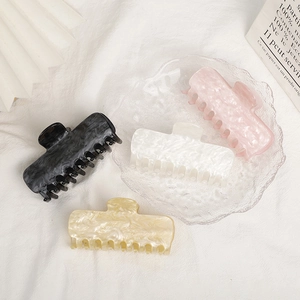 Set of four large acrylic hair claws in black, white, pink and beige with marble texture