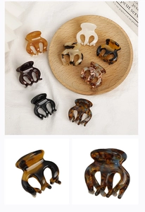 Macro view of mini acetate hair claw clips in tortoiseshell and marble patterns