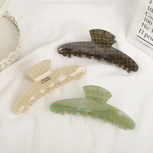 Three elegant checkered acetate hair claw clips in grey, beige and green colors
